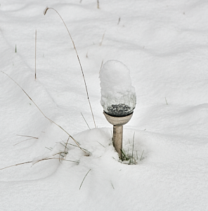 Snow covered solar garden light